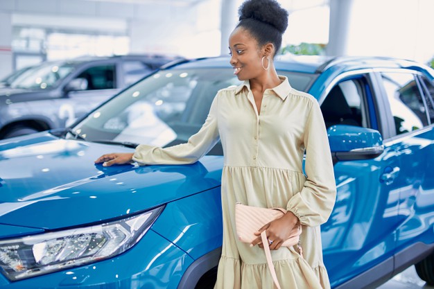 black-african-american-woman-posing-blue-car-dealership_183219-2685
